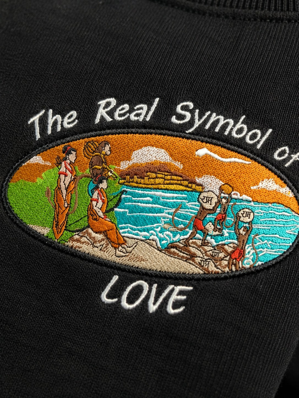 Close-up of The Real Symbol of LOVE embroidery with Ram Setu scene
